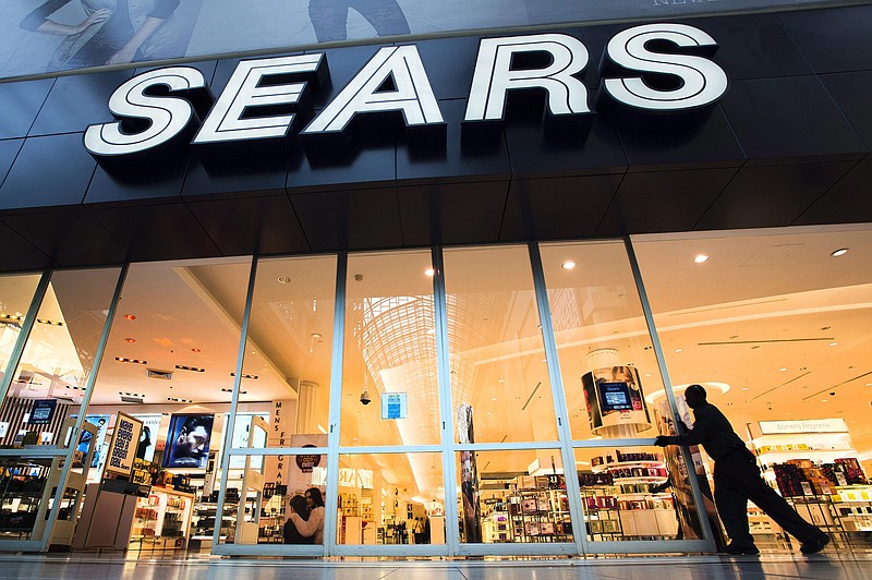 (AP Photo/The Canadian Press In this Oct, 29, 2013, file photo, the Sears store at Eaton Centre in Toronto opens its doors for business. Sears, in need of cash, sold seven locations to CBL & Associates Properties Inc.