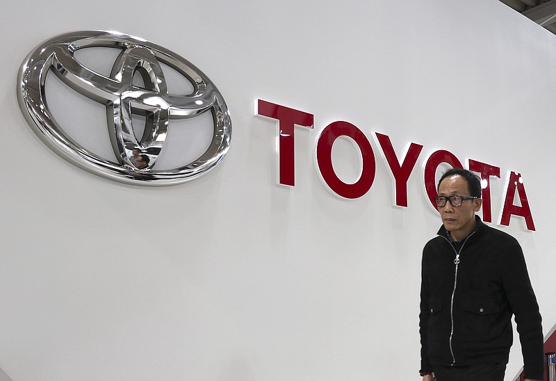 
              A visitor walks past the log of Toyota Motor Corp. at its showroom in Tokyo, Monday, Jan. 30, 2017. Toyota has relinquished the title of the world's biggest automaker, reporting Monday that it sold 10.175 million vehicles worldwide in 2016, fewer than Volkswagen's 10.31 million. (AP Photo/Shizuo Kambayashi)
            