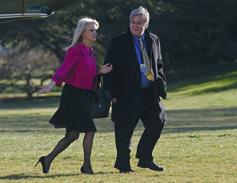 
              In this Jan. 26, 2017, photo White House counselor Kellyanne Conway, left, and senior adviser Steve Bannon, right, walk on the South Lawn of the White House in Washington, after returning via Marine One from a trip to Philadelphia with President Donald Trump. Since taking office 10 days ago, President Donald Trump has moved to consolidate power within a small cadre of close aides at the White House. He’s added a senior political adviser to the National Security Council and appears to have cut out Cabinet secretaries from decision making on some of his top policies, including the immigration and refugee order that led to protests, legal challenges and temporary detention of some legal U.S. residents this weekend. (AP Photo/Susan Walsh)
            