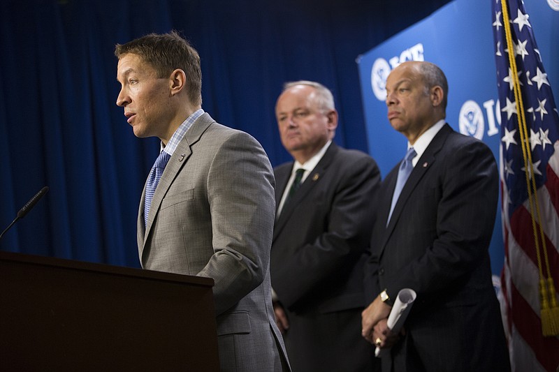 
              FILE - In this March 18, 2014, file photo, US Immigration and Customs Enforcement Deputy Director Daniel Ragsdale, left, accompanied by US Customs and Border Protection Deputy Commissioner Thomas S. Winkowski, center, and Homeland Security Secretary Jeh Johnson speaks during a news conference at the U.S. Immigration and Customs Enforcement (ICE) headquarters in Washington to discuss the results of a international operation involving an underground child pornography website. The Department of Homeland Security announced on Monday, Jan. 30, 2017, that Ragsdale has been replaced as acting head of the agency by Thomas Homan. (AP Photo/ Evan Vucci, File)
            
