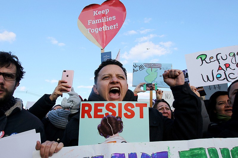 Jorge Torres takes part in a weekend rally protesting President Donald Trump's executive order banning travel to the U.S. by citizens of Iraq, Syria, Iran, Sudan, Libya, Somalia or Yemen, in Elizabeth, N.J., outside the Homeland Security Detention Center. (Thomas E. Franklin/The Record via AP)