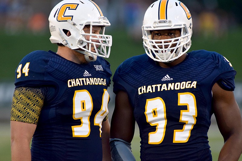 UTC defensive lineman Taylor Reynolds (94) and Keionta Davis (93) confer before a play.  The University of Tennessee/Chattanooga Mocs hosted the Shorter University Hawks in NCAA football action on Sept. 1, 2016. 