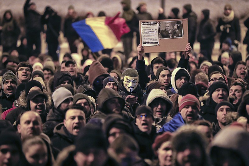 
              Protesters march outside the Justice Ministry in Bucharest, Romania, Sunday, Jan. 29, 2017. Some 10.000 people marched through the Romanian capital and other cities to protest a government proposal to pardon thousands of prisoners which critics say could reverse the anti-corruption fight. (AP Photo/Vadim Ghirda)
            