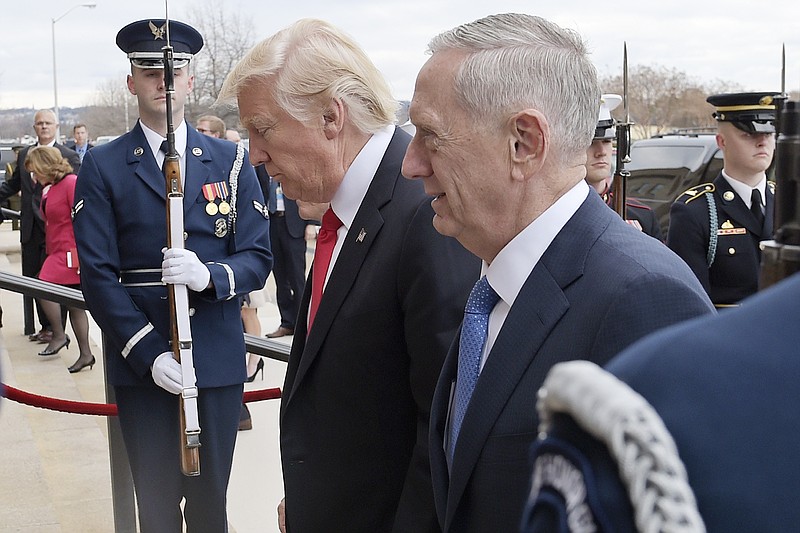 In this Jan. 27, 2017, file photo, U.S. Defense Secretary Jim Mattis, right, and U.S. President Donald Trump walk into the Pentagon in Washington. Mattis is making his debut with a visit to staunch U.S. allies South Korea and Japan, both of which host tens of thousands of American troops and, for good reason, see North Korea as their biggest national security threat. (AP Photo/Susan Walsh, File)