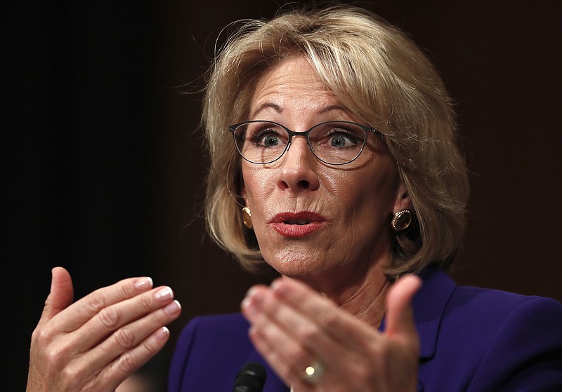 
              FILE - In this Jan. 17, 2017, file photo, Education Secretary-nominee Betsy DeVos testifies on Capitol Hill in Washington. Republicans are muscling more of President Donald Trump’s Cabinet nominees to the cusp of Senate confirmation over Democratic objections, with committees poised to advance his picks to head agencies in the thick of partisan battles over health care, legal protections, education and the economy. (AP Photo/Carolyn Kaster, File)
            