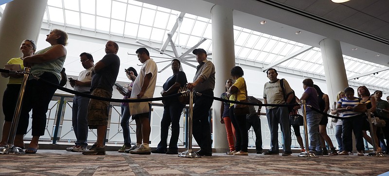 FILE - In this Sept. 3, 2014 photo, people wait in line to sign up for unemployment in Atlantic City, N.J. Payroll processor ADP reports how many jobs private employers added in September on Wednesday, Oct. 1, 2014. (AP Photo/Mel Evans, File)