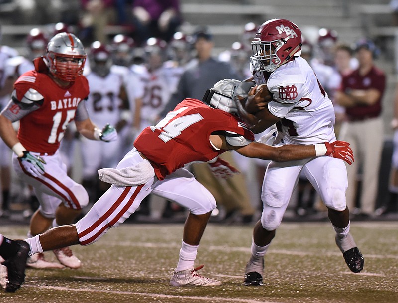 MBA's Ty Chandler tries to shed Baylor's Daniel Monroe during a 2015 game. Chandler, one of the top running backs in Tennessee high school football history, signed with Tennessee on Wednesday.