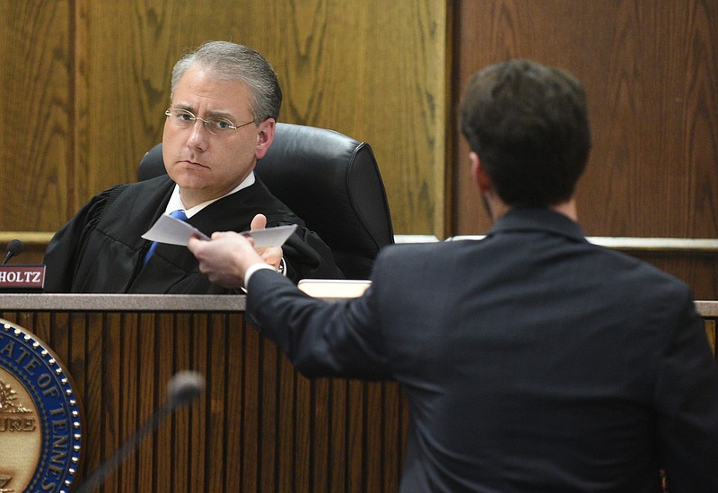 Executive Assistant District Attorney Lance Pope, right, hands a document to Judge Tom Greenholtz during a sentencing hearing for Valerie Bray Wednesday, Feb. 1, 2017. Bray pleaded guilty to hitting and killing runner Cameron Bean in Sept. 2015.