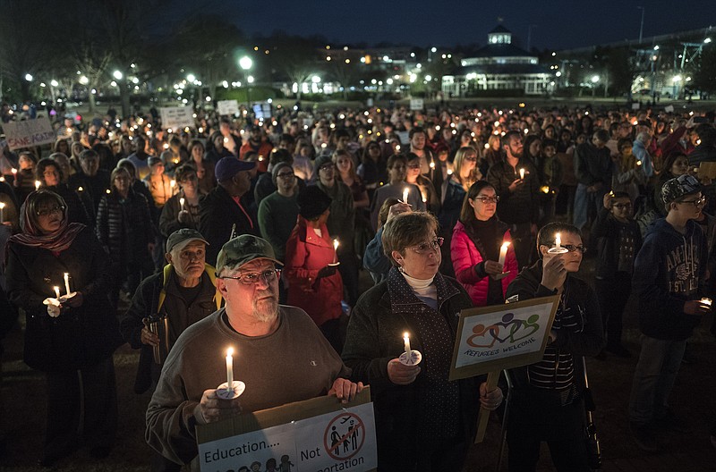 People gather at a vigil in support of immigrants held at Coolidge Park on Wednesday, Feb. 1, 2017, in Chattanooga, Tenn., in the wake of President Donald J. Trump's executive order on immigration. The vigil, titled "We All Belong," was held in partnership with Bridge Refugee Services.