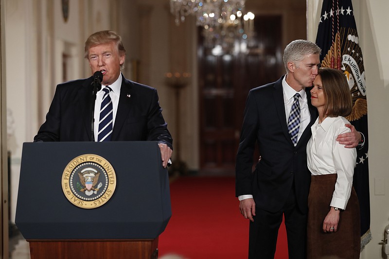 
              President Donald Trump speaks in the East Room of the White House in Washington, Tuesday, Jan. 31, 2017, to announce Judge Neil Gorsuch as his nominee for the Supreme Court. Gorsuch kisses his wife Louise. (AP Photo/Carolyn Kaster)
            