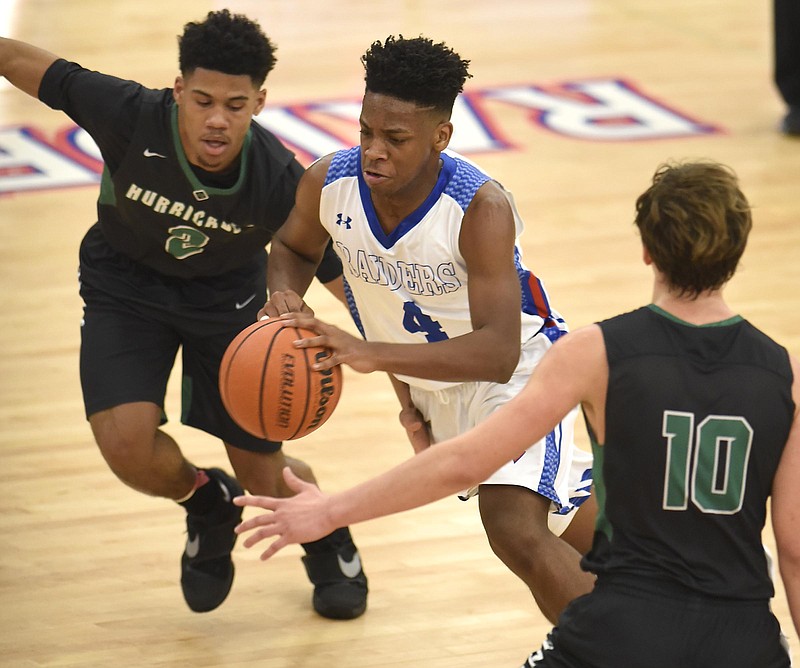 Cleveland's Mullek Bradford (4) dribbles between East Hamilton's Cam Montgomery (2) and Noah Fager (10).  The East Hamilton Hurricanes visited the Cleveland Blue Raiders in TSSAA basketball action on February 3, 2017.