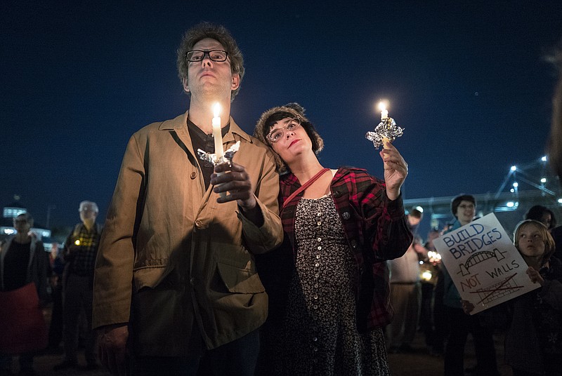 Berry Carroll, left, and Beth Long hold candles at a vigil in support of immigrants held at Coolidge Park on Wednesday, Feb. 1, 2017, in Chattanooga, Tenn., in the wake of President Donald J. Trump's executive order on immigration. The vigil, titled "We All Belong," was held in partnership with Bridge Refugee Services.