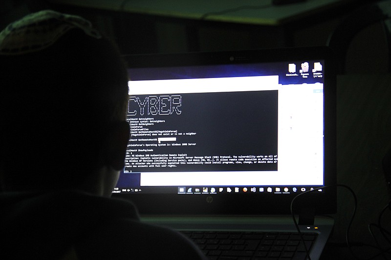 
              This photo made on Sunday Jan.1, 2017, shows a tenth grader attending a class how to investigate a computer network that has been hacked in Beit Shemesh, Israel. In its quest to become a world leader in cyber security and technology, Israel is placing its hopes in the country's youth. (AP Photo/Daniel Estrin)
            