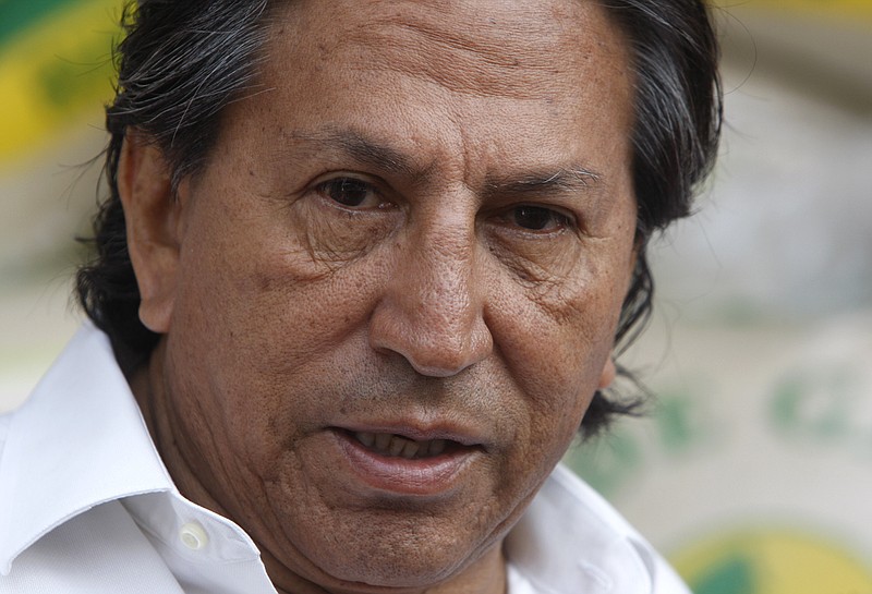 
              FILE - In this March 17, 2011 file photo, Peru's former President Alejandro Toledo campaigns for reelection at the Santa Anita wholesale market in Lima, Peru. Peruvian authorities said they searched Toledo's house on Saturday, Feb. 4, 2017 in a case involving alleged bribes from a construction firm under investigation in a major corruption probe in Brazil. Toledo currently is in Paris and denied the charges by telephone to Peruvian media. (AP Photo/Karel Navarro, File)
            