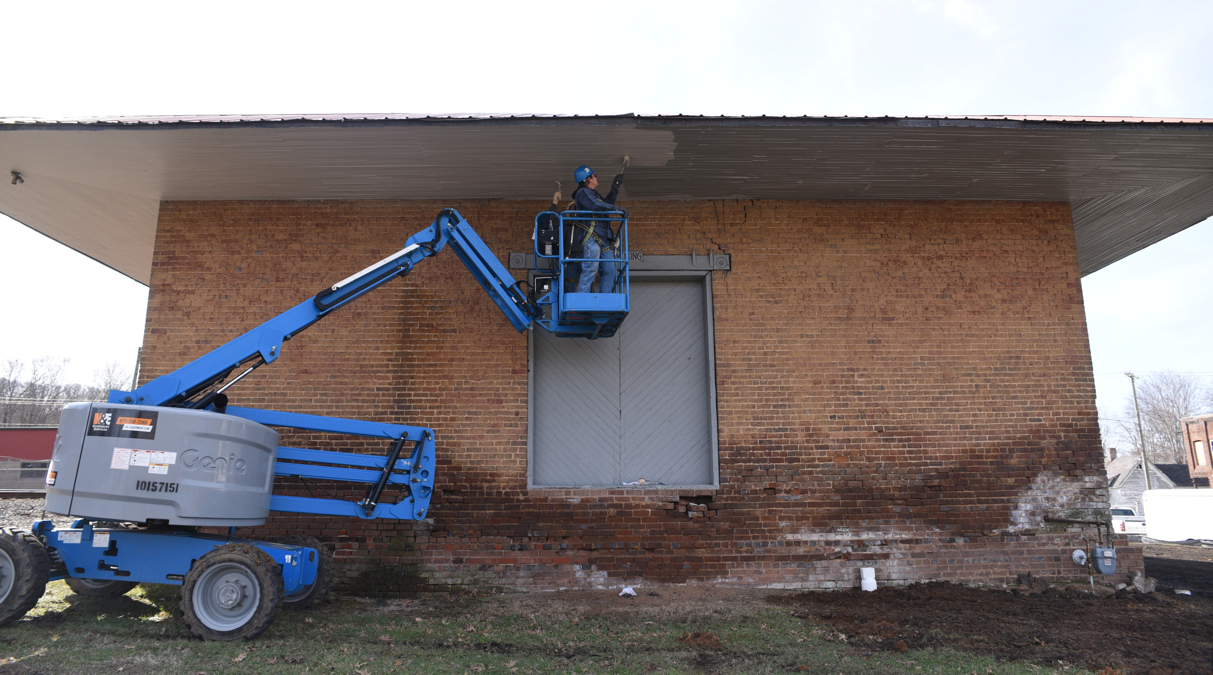 Anita Geiser, foreground, and Clifford Merrell paint the Niota Depot, which houses the Niota City Hall Tuesday, January 31, 2017.