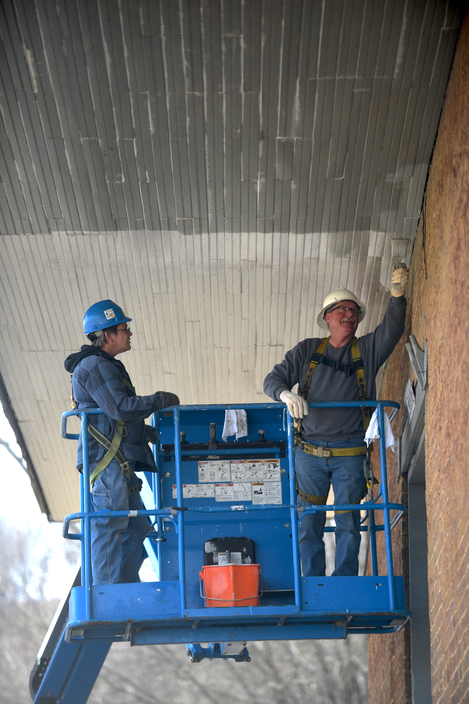 Anita Geiser, left, and Clifford Merrell paint the Niota Depot, which houses the Niota City Hall Tuesday, January 31, 2017.