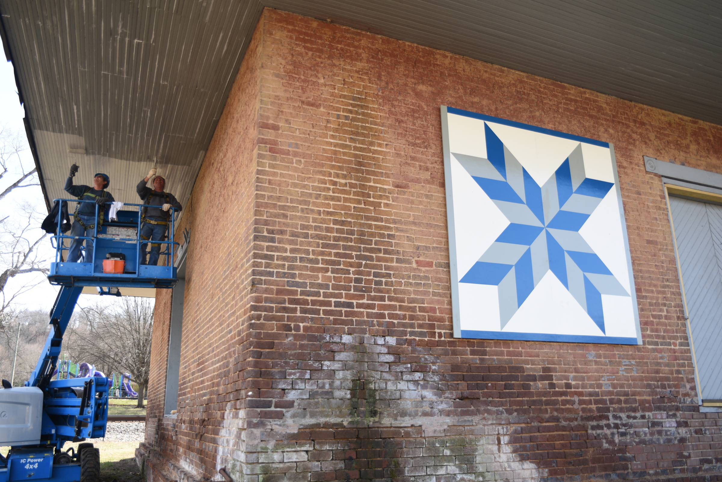 Anita Geiser, left, and Clifford Merrell paint the Niota Depot, which houses the Niota City Hall Tuesday, January 31, 2017.