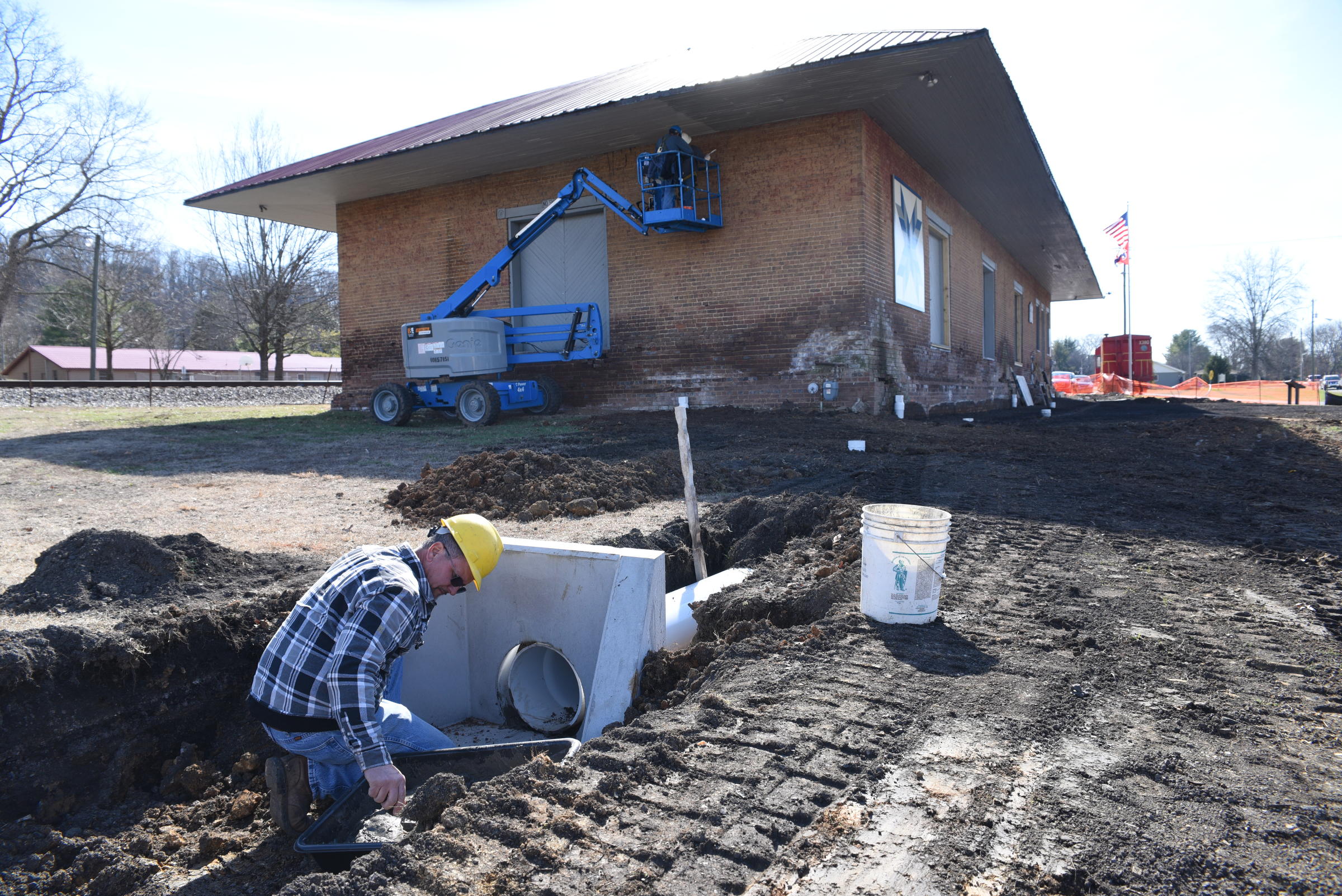 Tim Kimsey grouts a tile near the Niota Depot, which houses the Niota City Hall Tuesday, January 31, 2017.
