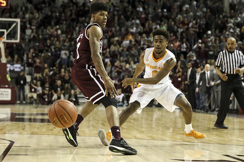 Tennessee point guard Jordan Bowden, right, slips a pass by Mississippi State during Saturday's game in Starkville. The Vols led by 19 points in the first half but lost 64-59 to the Bulldogs, who were 91-74 losers in Knoxville last month.
