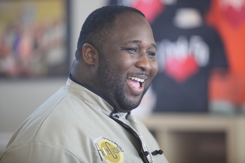 
Chef Jernard Wells laughs during a cooking class at his recently opened  Haute Cuisine on East Brainerd Road Monday afternoon. 