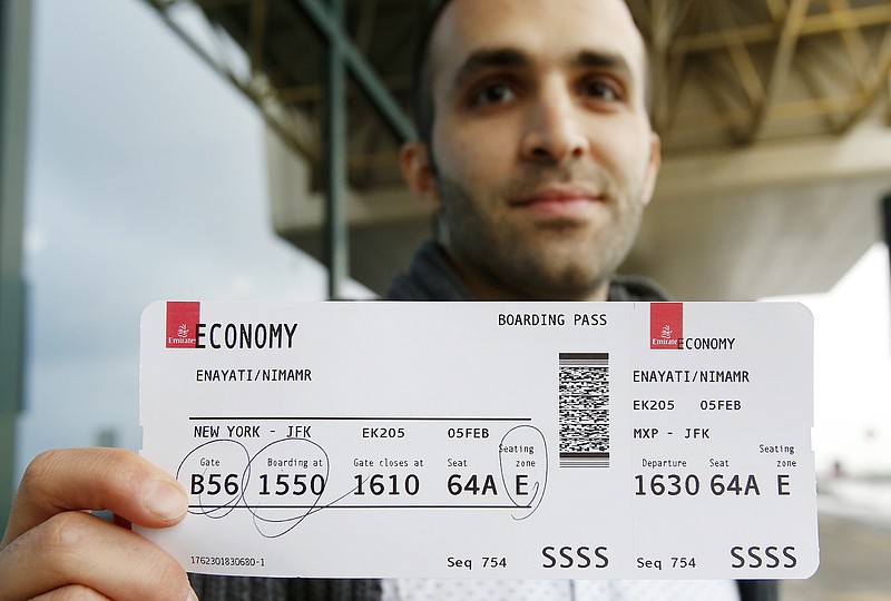 
              Iranian-born bioengineer researcher Nima Enayati holds up his boarding pass at the Milan's Malpensa International airport in Busto Arsizio, Italy, Sunday, Feb. 5, 2017. Just hours after an appeals court blocked an attempt to re-impose the travel ban, Iranian researcher Nima Enayati checked in on an Emirates Airline flight direct from Milan’s Malpensa airport to New York’s JFK on Sunday afternoon. (AP Photo/Antonio Calanni)
            