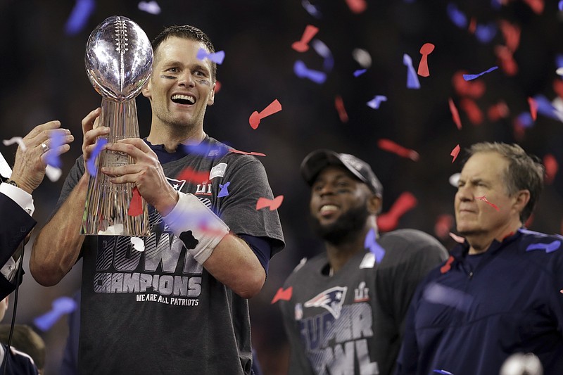
              New England Patriots' Tom Brady holds the Vince Lombardi Trophy after defeating the Atlanta Falcons in overtime at the NFL Super Bowl 51 football game Sunday, Feb. 5, 2017, in Houston. The Patriots defeated the Falcons 34-28. At right is Patriots head coach Bill Belichick. (AP Photo/Darron Cummings)
            
