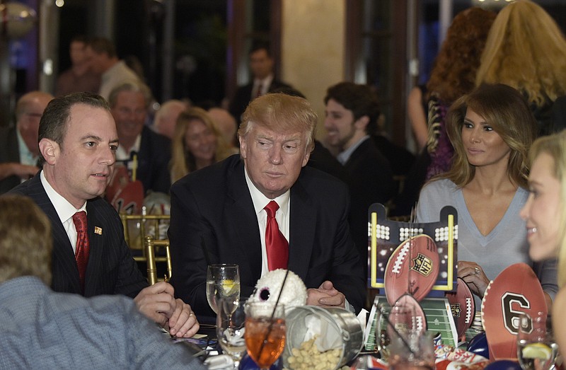 
              President Donald Trump, center, first lady Melania Trump, second from right, and White House Chief of Staff Reince Priebus attend a Super Bowl party at Trump International Golf Club in West Palm Beach, Fla., Sunday, Feb. 5, 2017. (AP Photo/Susan Walsh)
            