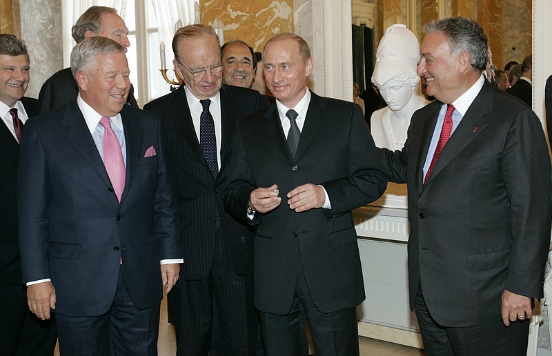 
              FILE - In this  June 25, 2005, file photo, Russian President Vladimir Putin, second right, holds the diamond-encrusted 2005 Super Bowl ring belonging to New England Patriots owner Robert Kraft, left , as News Corp. Chairman Rupert Murdoch, second left, and Citigroup Chairman Sanford Weill look on during a meeting of American business executives at the 18th century Konstantin Palace outside St. Petersburg, Russia. Kraft won his fifth Super Bowl ring on Feb. 5, 2017, but his third ring remains with Putin. (AP Photo/Alexander Zemlianichenko, File)
            
