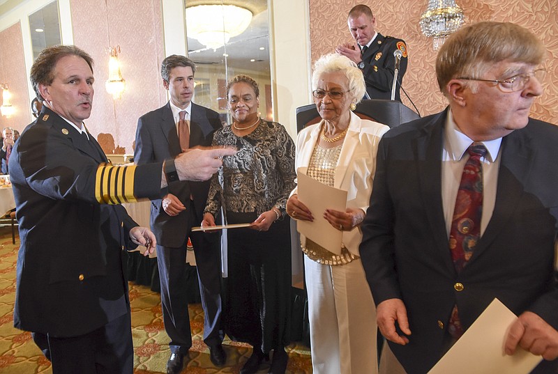Chattanooga Fire Chief Chris Adams, left, and Mayor Andy Berke, recognize three Civilian award recipients, from left, Claudia Sears, Mary Smith and Ed Wilson for their part in assisting at the Woodmore Elementary bus accident Monday at the department's annual awards dinner at the Chattanooga Choo Choo.