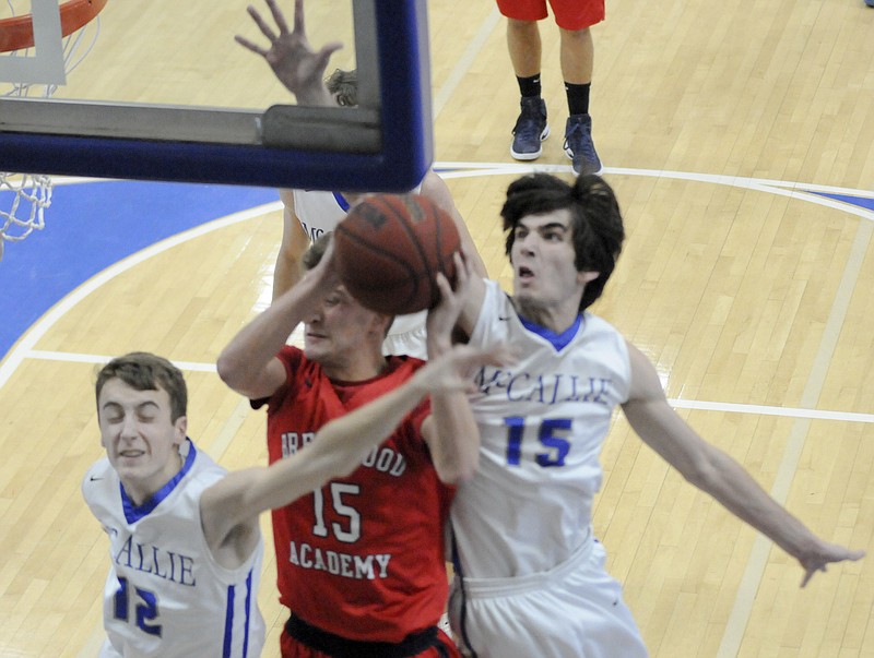 McCallie's Henley Edge (12) and Mac Hunt (15) defend under the basket as Brentwood's Garrett Suedekum (15) attempts the shot in first half action Tuesday night.