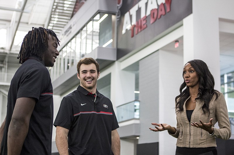 Georgia freshman quarterback Jake Fromm, center, shares a laugh with freshman safety Richard LeCounte and the SEC Network's Maria Taylor during national signing day festivities last Wednesday in Athens.