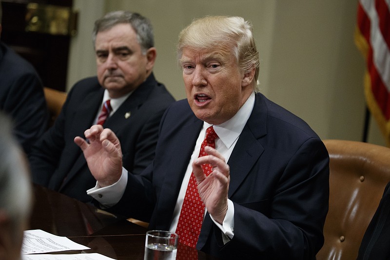 
              St. Charles, La. Parish Sheriff Greg Champagne, the president of the National Sheriffs Association listens at left as President Donald Trump speaks during a meeting with county sheriffs in the Roosevelt Room of the White House in Washington, Tuesday, Feb. 7, 2017. (AP Photo/Evan Vucci)
            