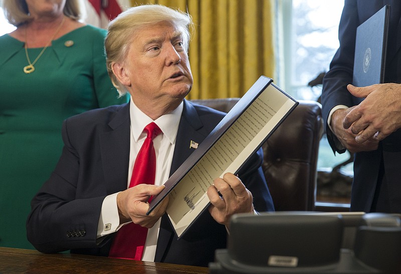 President Donald Trump after signing an executive order calling for a rewriting of major provisions of the 2010 Dodd-Frank Act on Feb. 3 in the Oval Office of the White House.