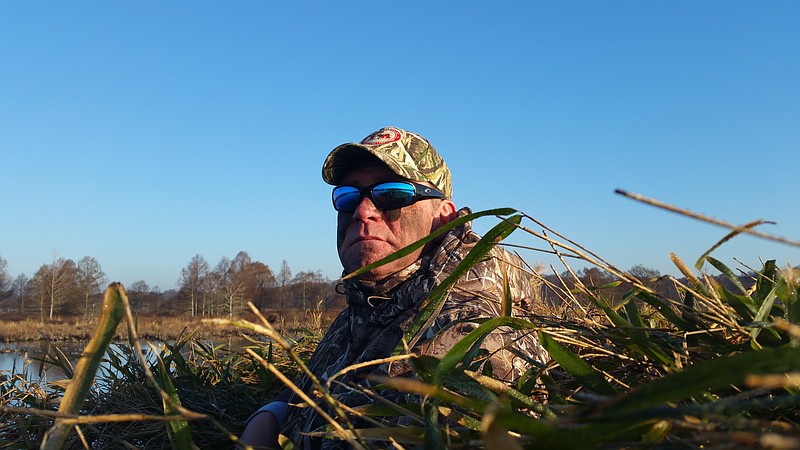 Chattanooga resident Jim Rosemann scans Reelfoot Lake from a duck blind during a successful recent two-day hunting trip in northwestern Tennessee.