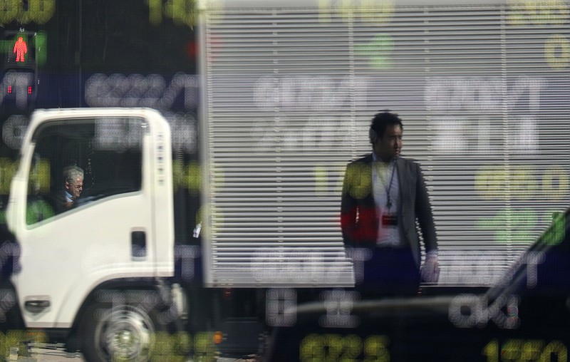 
              People are reflected on an electronic stock indicator of a securities firm in Tokyo, Wednesday, Feb. 8, 2017. Asian shares were mostly lower Wednesday following a subdued session on Wall Street as energy stocks were weighed down by falling oil prices. (AP Photo/Shizuo Kambayashi)
            