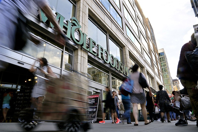 
              FILE - In this Wednesday, June 24, 2015, file photo, pedestrians pass in front of a Whole Foods Market store in Union Square in New York. Whole Foods said Wednesday, Feb. 8, 2017, that sales fell 2.4 percent at established locations, marking the sixth straight quarter of declines as it faces competitive pressures. (AP Photo/Julie Jacobson, File)
            