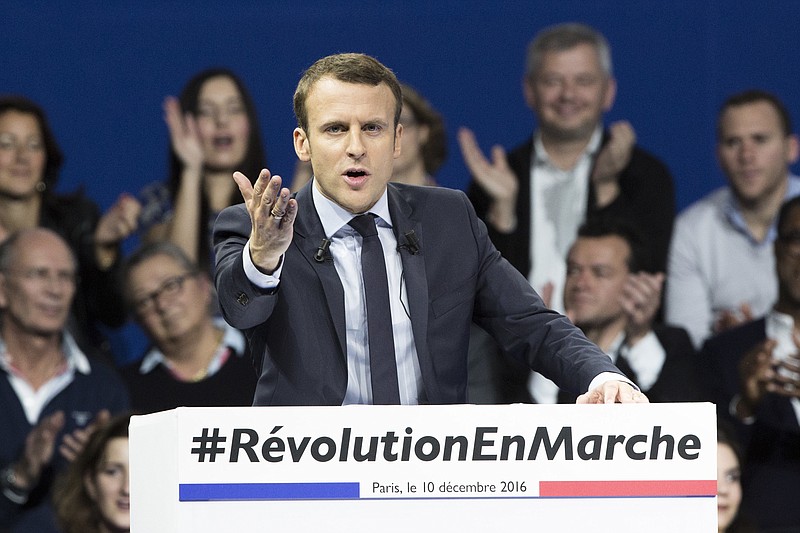 
              FILE - In this Saturday, Dec. 10, 2016 file picture, former French Economy Minister and candidate for next year's presidential election, Emmanuel Macron gestures as he delivers his speech during a campaign meeting in Paris, France. "Emmanuel Macron has humorously poo-pooed online chatter that he is having a gay affair. To hoots of laughter, the independent candidate this week delighted his supporters by making fun of rumors that he is leading a secret double life with a man." (AP Photo/Kamil Zihnioglu, File)
            