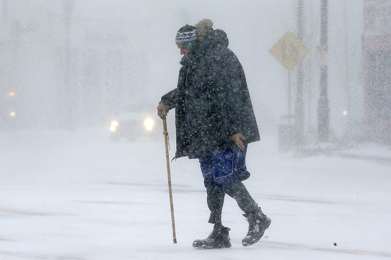 
              Todd Fike, crosses the street during a snowstorm, Thursday, Feb. 9, 2017, in Framingham, Mass. (AP Photo/Steven Senne)
            