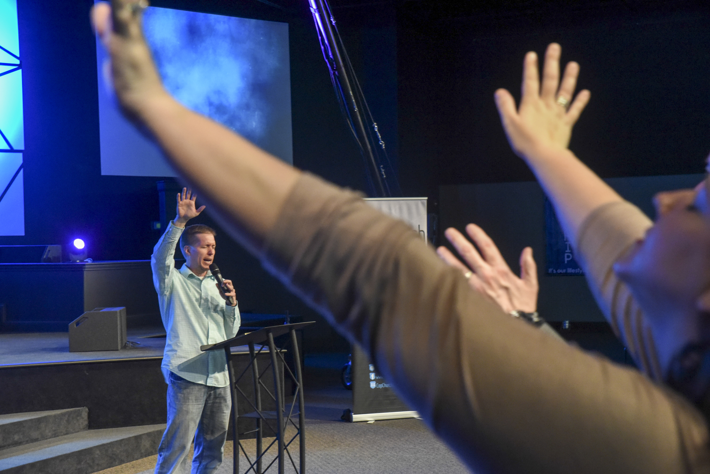 Cop Church Pastor Jonathan Parker leads opening prayer at a service in Metro Tabernacle.