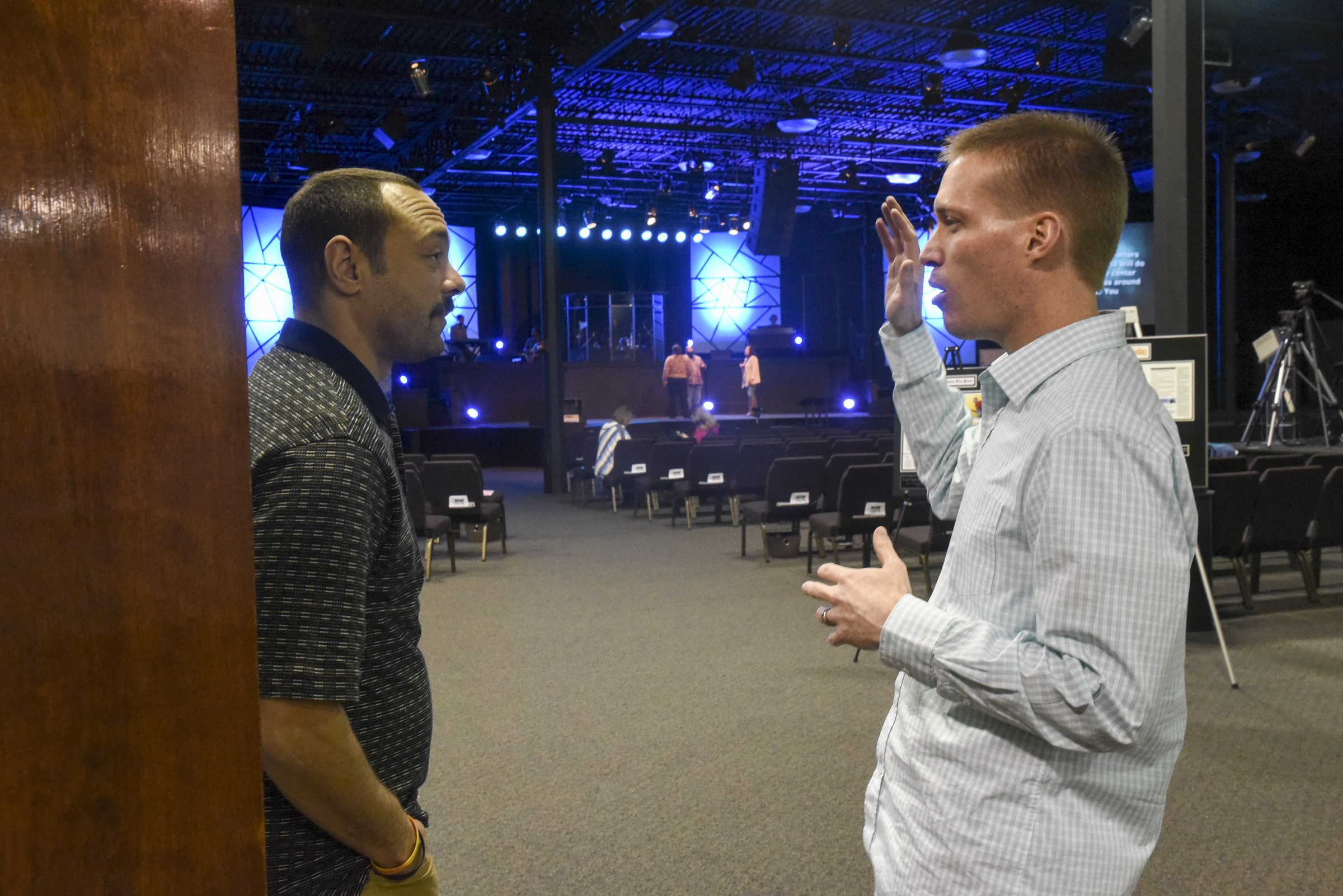 Pastor Jonathan Parker, right, talks with Chattanooga Police Officer Les Corbin before Tuesday's service at the Metro Tabernacle.