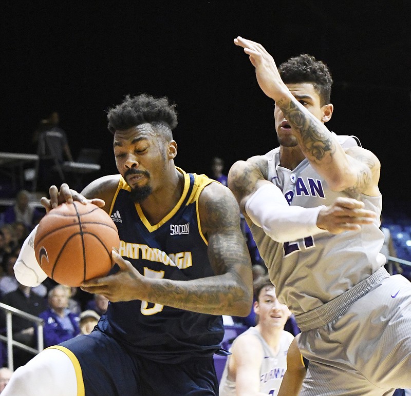 UTC's Justin Tuoyo beats Furman's Kris Acox to the ball for a rebound during Thursday night's game.