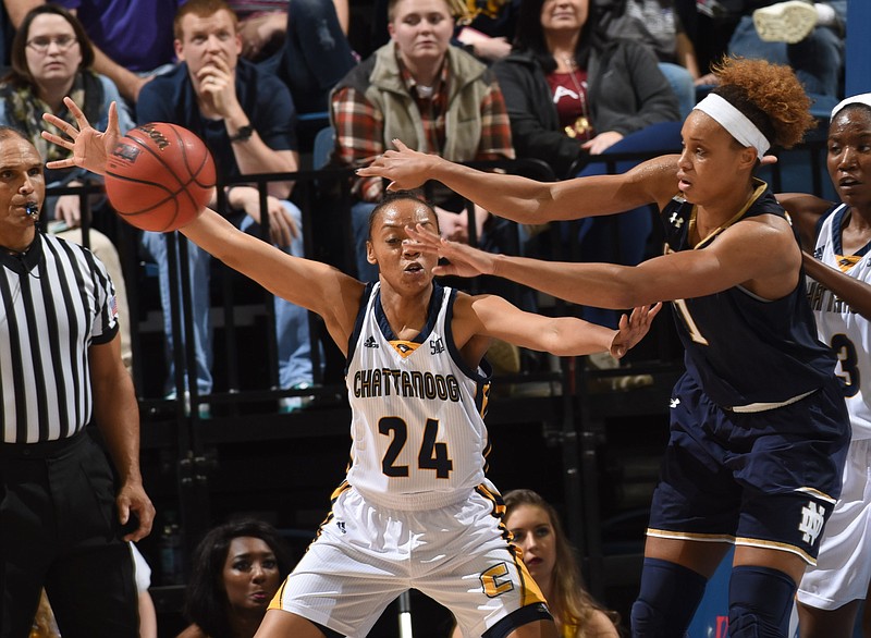 Notre Dame's Brianna Turner stretches to pass the ball beyond the reach of UTC's Nakeia Burks (24) in second half action Tuesday at McKenzie Arena.