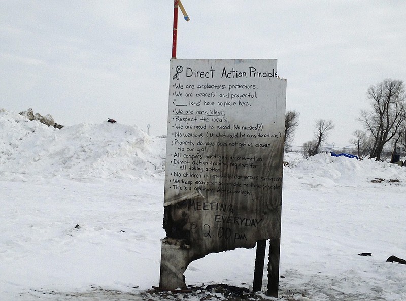 A sign is seen at an encampment set up near Cannon Ball, N.D., Wednesday, Feb. 8, 2017, for opponents against the construction of the Dakota Access pipeline. Opponents have called for protests around the world Wednesday, Feb. 8, 2017, as the Army prepared to green-light the final stage of the $3.8 billion project's construction. The Army said Tuesday, Feb. 7, that it will allow the four-state pipeline to cross under a Missouri River reservoir in North Dakota, the last big chunk of construction. (AP Photo/James MacPherson)

