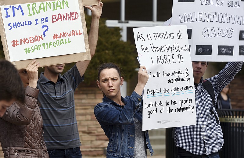 Allie Morgan, a University of Colorado graduate student, is among dozens of people at a travel ban protest at the University of Colorado in Boulder on Thursday, Feb. 9, 2017. ( Cliff Grassmick/Daily Camera via AP)

