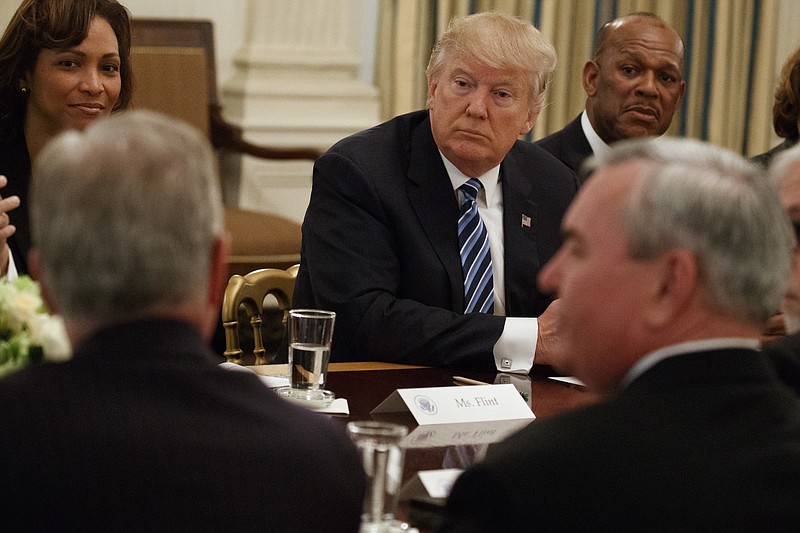 
              President Donald Trump listens during a meeting with airline executives in the State Dining Room of the White House in Washington, Thursday, Feb. 9, 2017. From left are, Deborah Ale Flint, executive director of Los Angeles World Airports; Trump; and UPS President of US operations Myron Gray. (AP Photo/Evan Vucci)
            