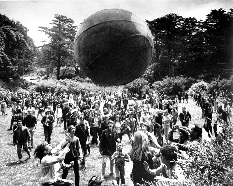 
              FILE - In this June 21, 1967, file photo, a crowd of hippies keep a large ball, painted to represent a world globe, in the air during a gathering at Golden Gate Park in San Francisco, to celebrate the summer solstice on June 21, day one of "Summer of Love." City officials have rejected a permit for a planned free concert intended to mark the 50th anniversary of the famed Summer of Love in Golden Gate Park that had been planned for June 2017. (AP Photo, File)
            