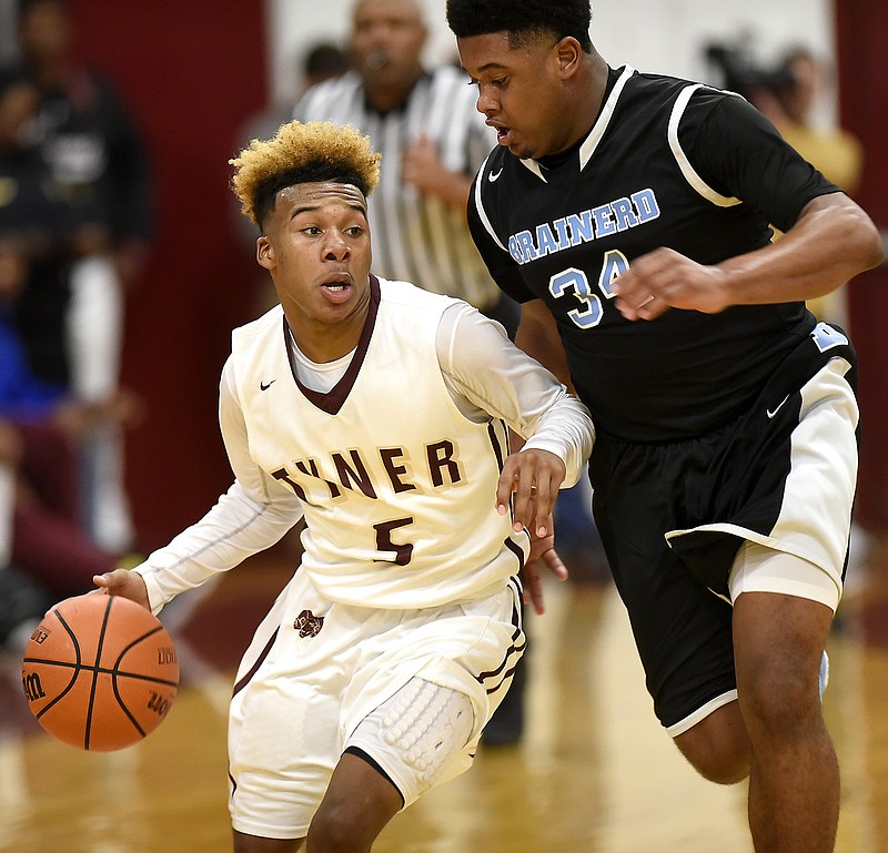 Tyner's KeMarkus Young (5) dribbles inside Brainerd's Jamaul Herman (34).  The Brainerd Panthers visited the Tyner Rams in TSSAA basketball action on February 10, 2017.