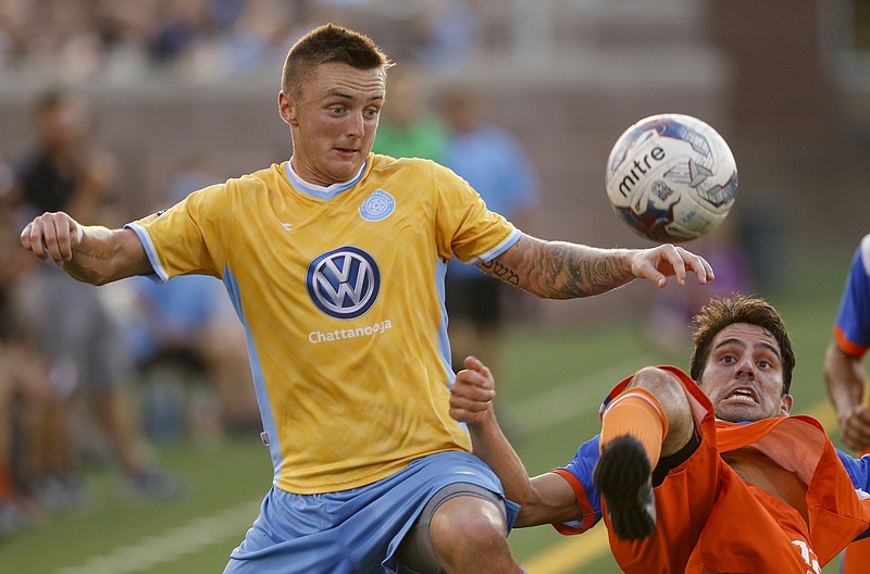 Chattanooga FC's Jon Finlay, left, works against Sonoma County Sol's Nicholas Lombardi during an NPSL playoff semifinal last July 30 at Finley Stadium, where CFC will host a friendly today against the new MLS team from Atlanta.