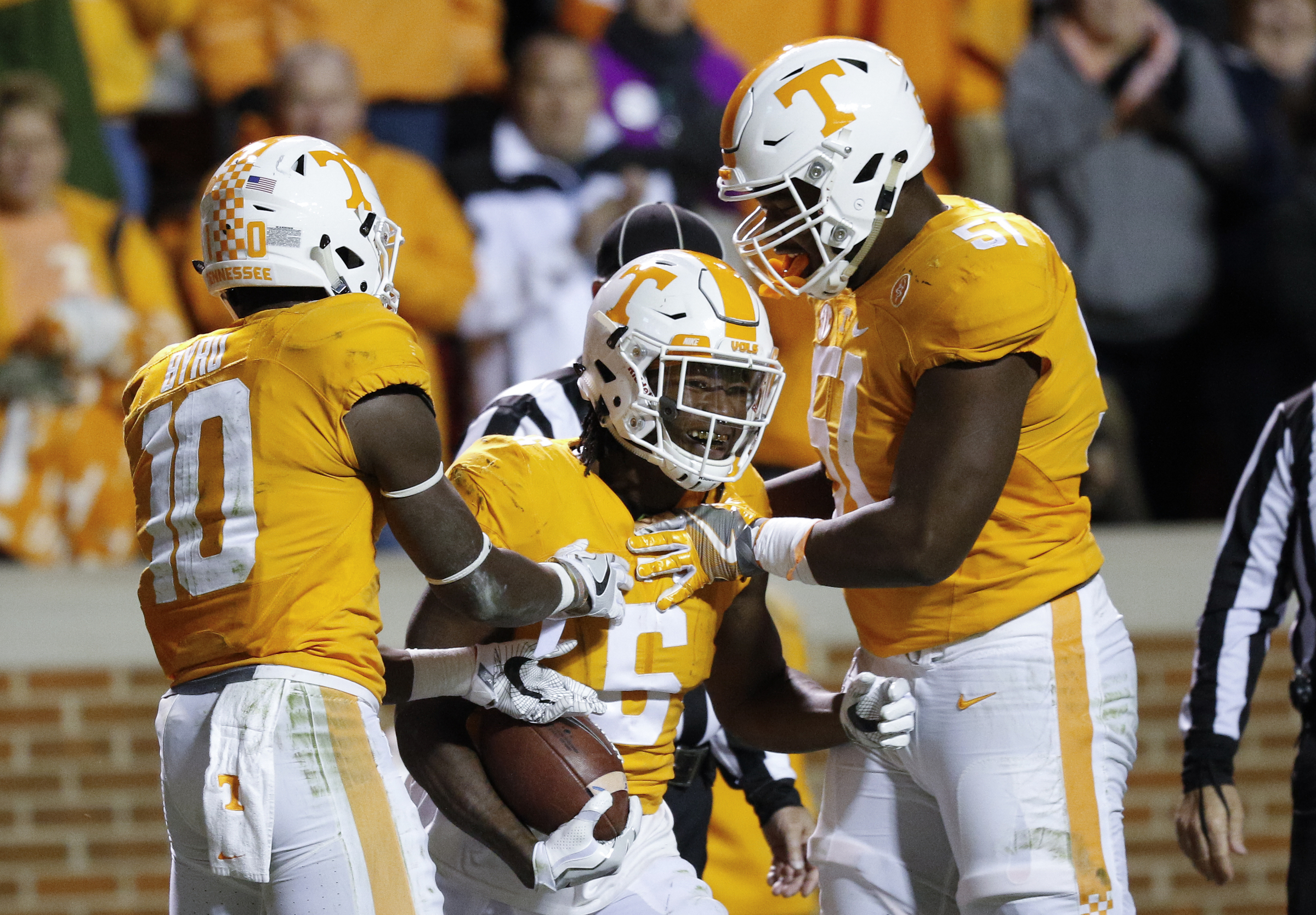 Tyler Byrd, left, and Drew Richmond, right, congratulate Tennessee runningback Alvin Kamara after a touchdown during the Vols' home football game against the Missouri Tigers at Neyland Stadium on Saturday, Nov. 19, 2016, in Chattanooga, Tenn. Tennessee won their final home game of the season 63-37.