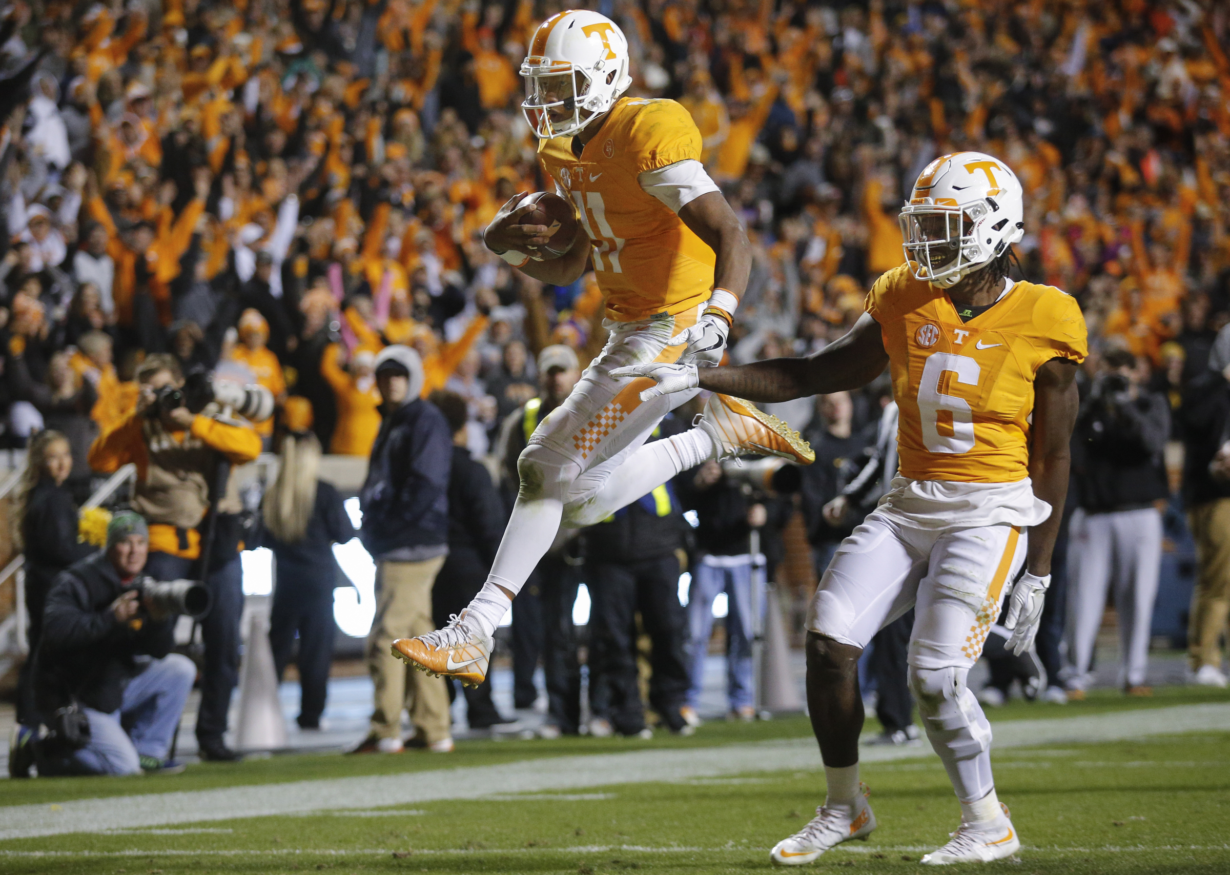 Tennessee quarterback Joshua Dobbs leaps into the end zone ahead of teammate Alvin Kamara for a touchdown during the Vols' home football game against the Missouri Tigers at Neyland Stadium on Saturday, Nov. 19, 2016, in Chattanooga, Tenn. Tennessee won their final home game of the season 63-37.